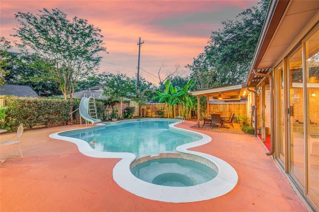 Hot tub and heated pool are the showpiece surrounded by covered seating areas