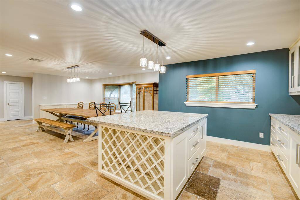 Island boasts storage on both sides, wine rack, & electrical