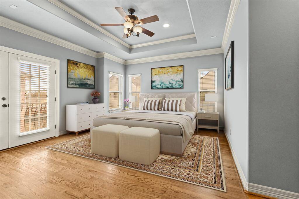 Virtually Staged: Unwind after a long day in this incredibly spacious primary bedroom! Featuring lots of natural light, wood floors, privacy blinds, and a tray ceiling with a ceiling fan.