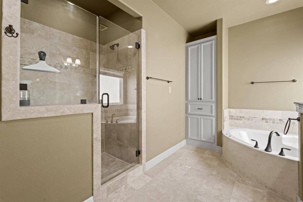 The Primary bathroom is complete with tile floors, and a glass enclosed shower with modern fixtures.
