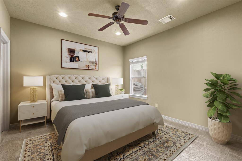 Virtually Staged: Wonderfully appointed secondary bedroom with carpet floors, a ceiling fan, recessed lighting, and a large walk-in closet. This room is located on the first floor.