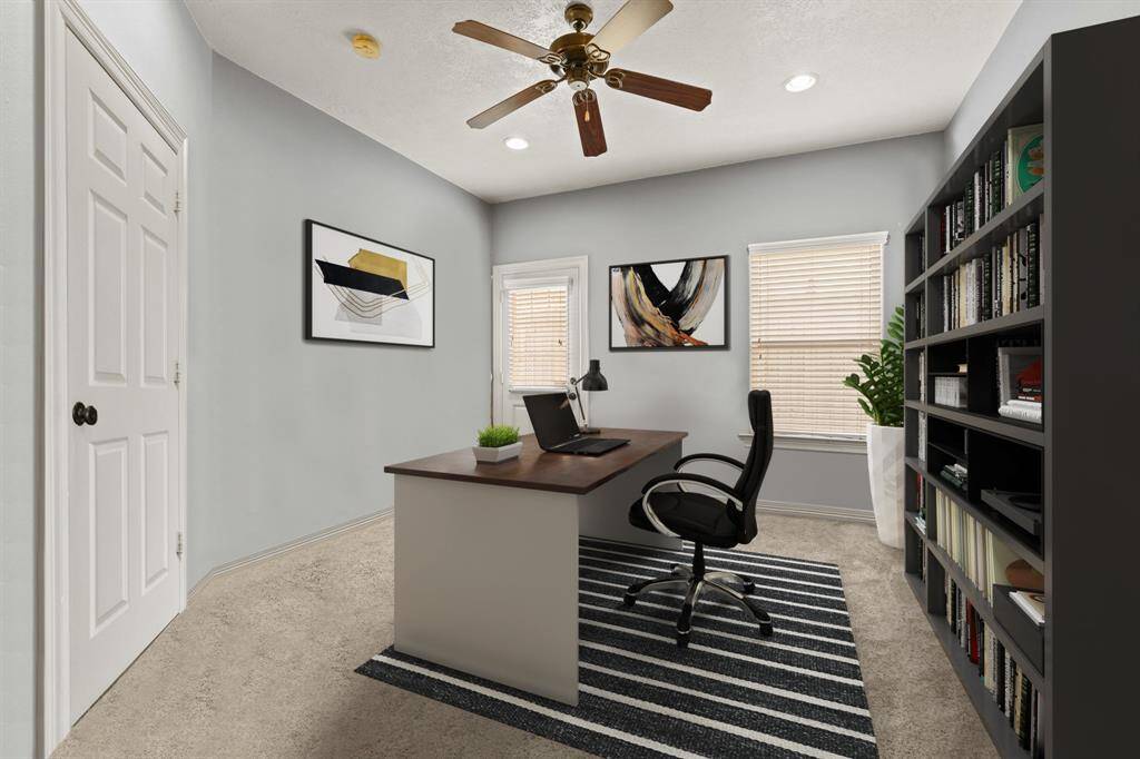 Virtually Staged: This flex room features carpet floors, recessed lighting, a ceiling fan, and windows with privacy blinds. Perfect for a home office and getting some work done. This room is located on the first floor.