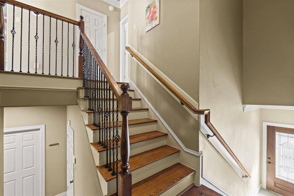 Upon entering you will be greeted right away with the staircase with iron details.