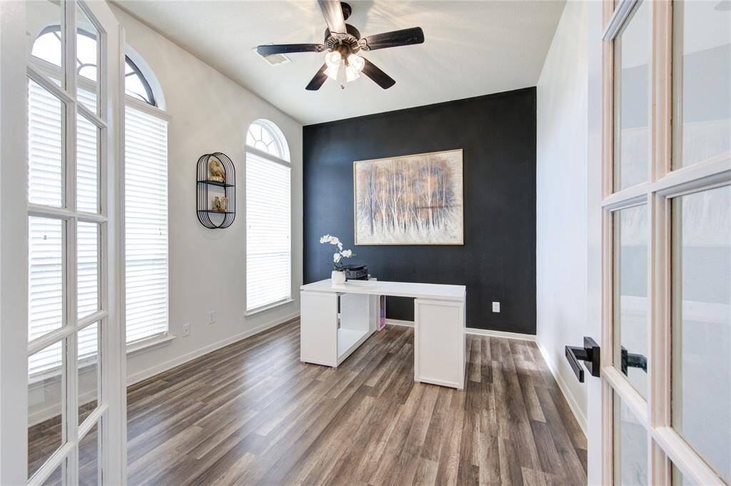 Elegant accent wall in office is framed by the French doors.