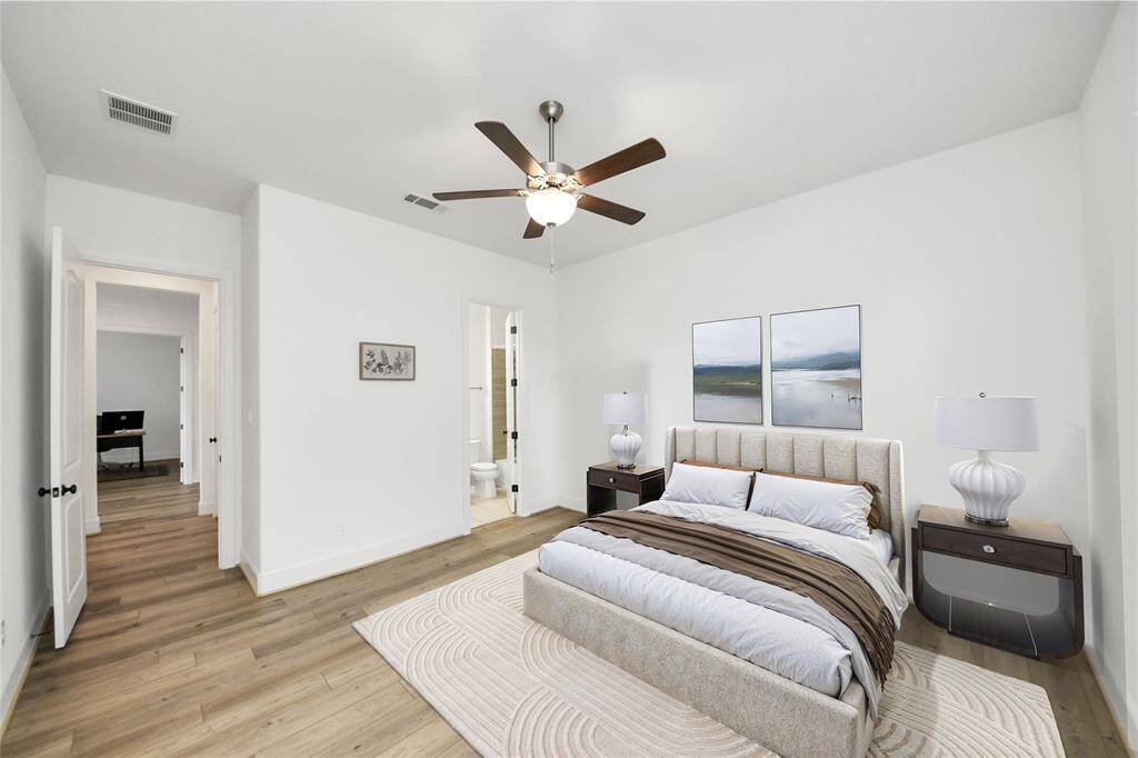 The secondary bedroom on the main level offers ideal convenience for multi-generational living, guest accommodations, or a private home office, complete with its own ensuite bath and walk-in closet. Virtually Staged