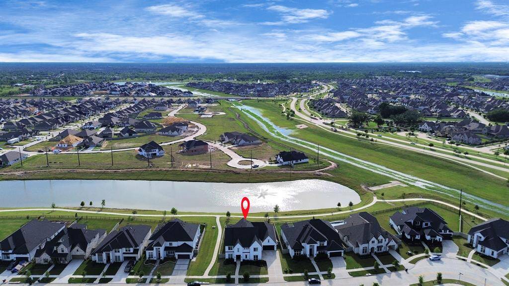 Graciously situated in front of the fountain on a prime waterfront 80ft lot in Pomona.
