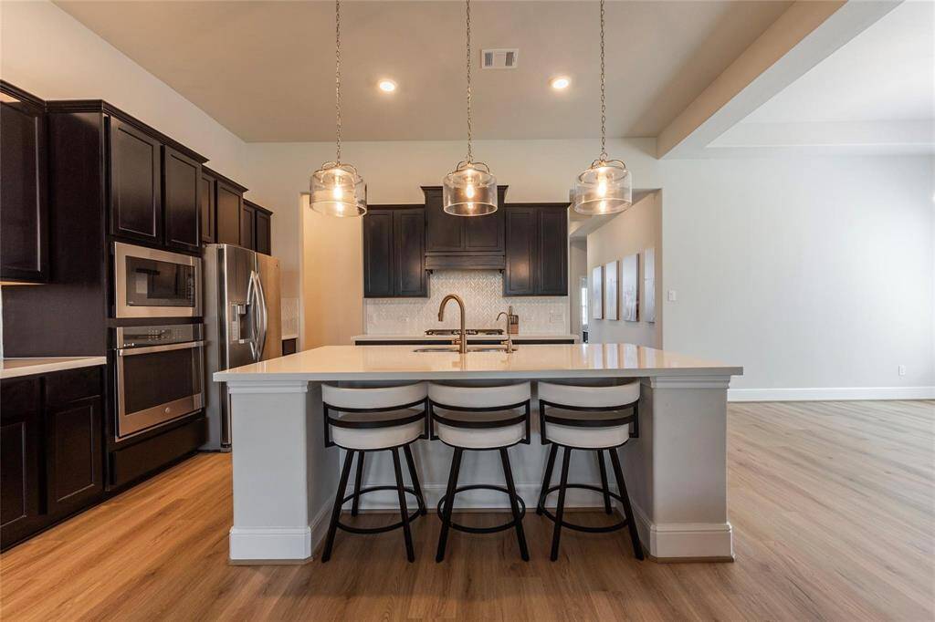 Stunning backsplash in this elegant open concept kitchen.