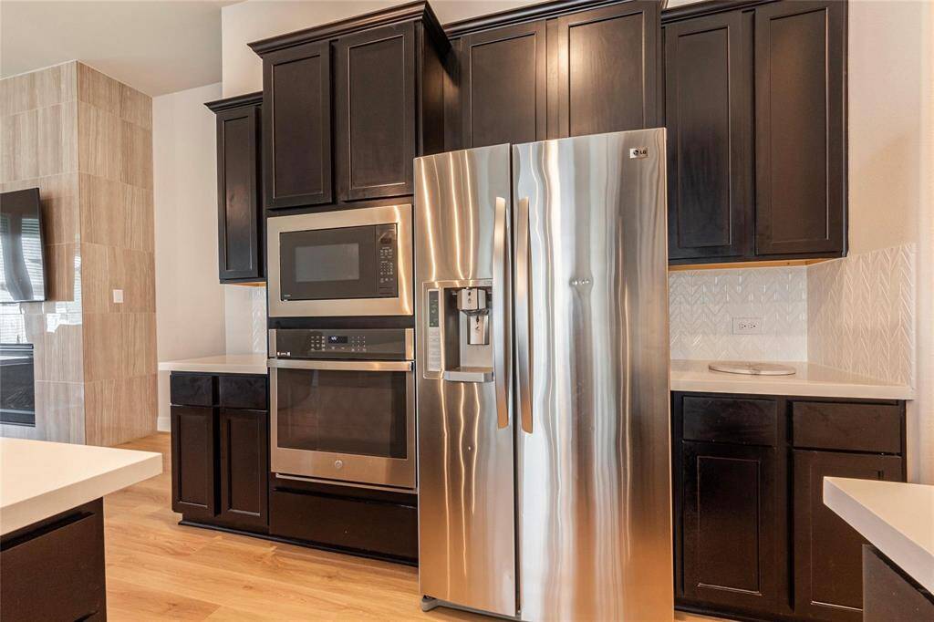 Stainless steel built-in oven and overhead built in microwave.