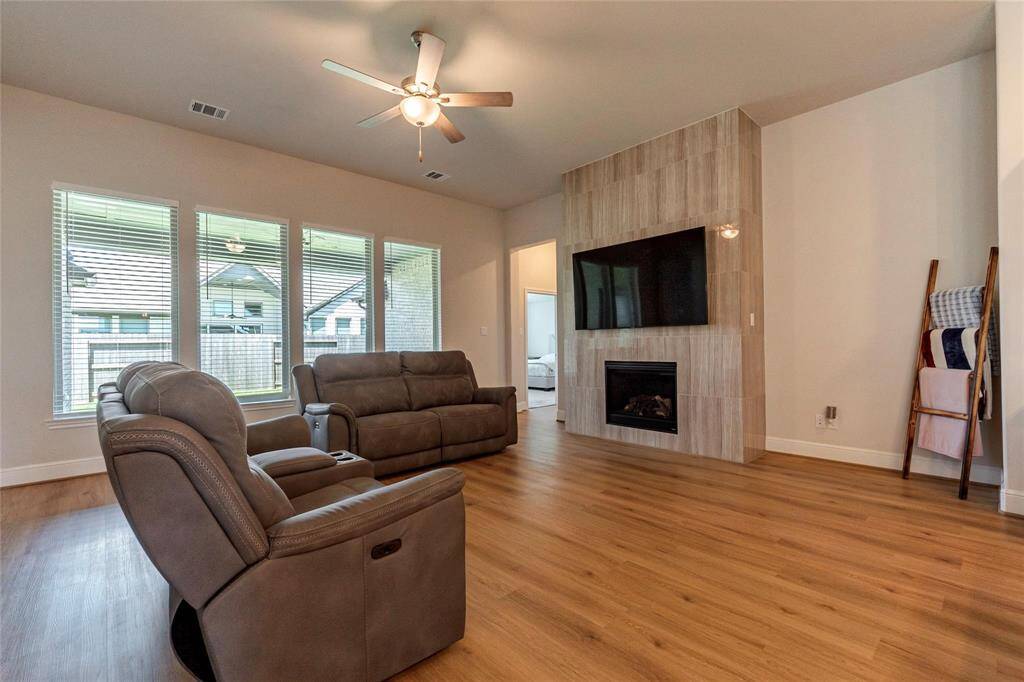 Attractive upgraded fireplace from floor-to-ceiling; wall-of-windows in the spacious family room.