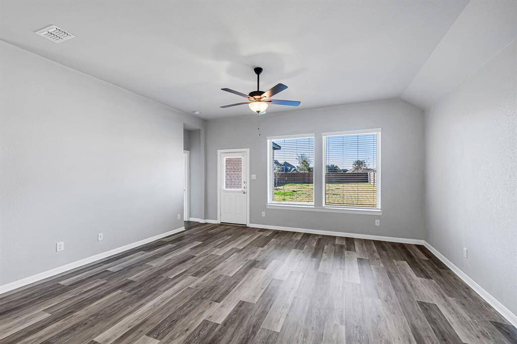 The living room has a nice view of the backyard.