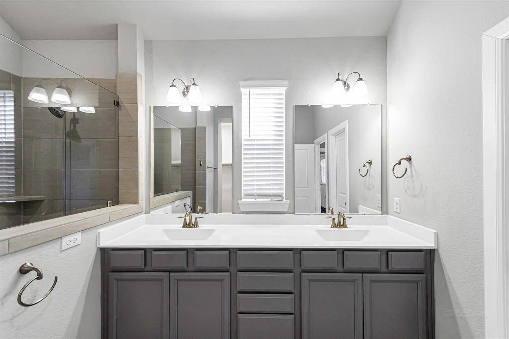 The double vanity allows for a lot of storage and the window in the bathroom provides natural light.
