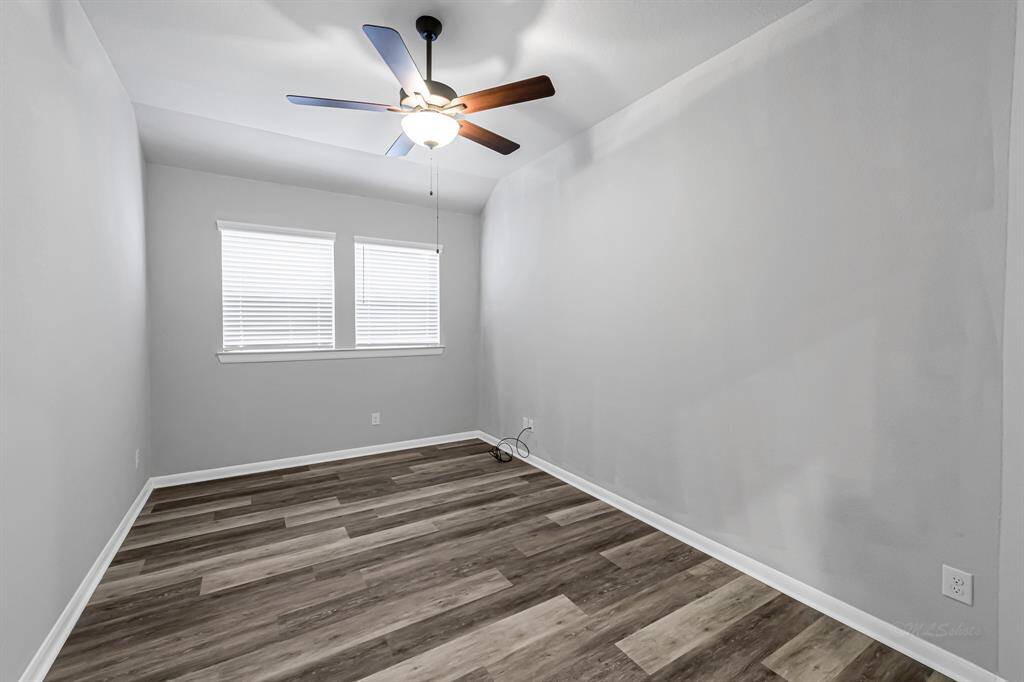 This office is generous in size and could also serve as a playroom or gameroom.