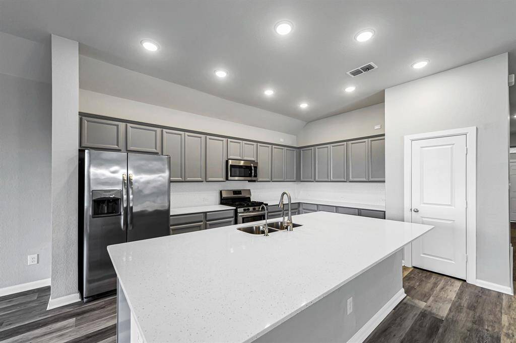 Check out the massive island, quartz countertops and stainless steel appliances!