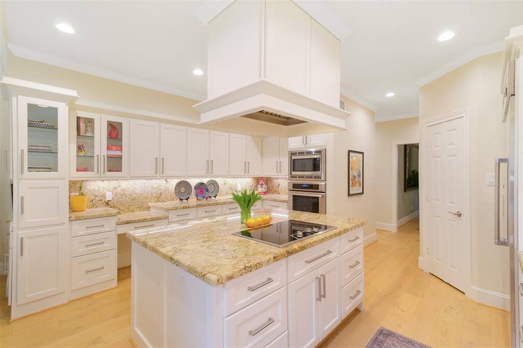 This view shows the Walk-In Pantry Door, Oven, Warmer, Microwave, and Island Stovetop.