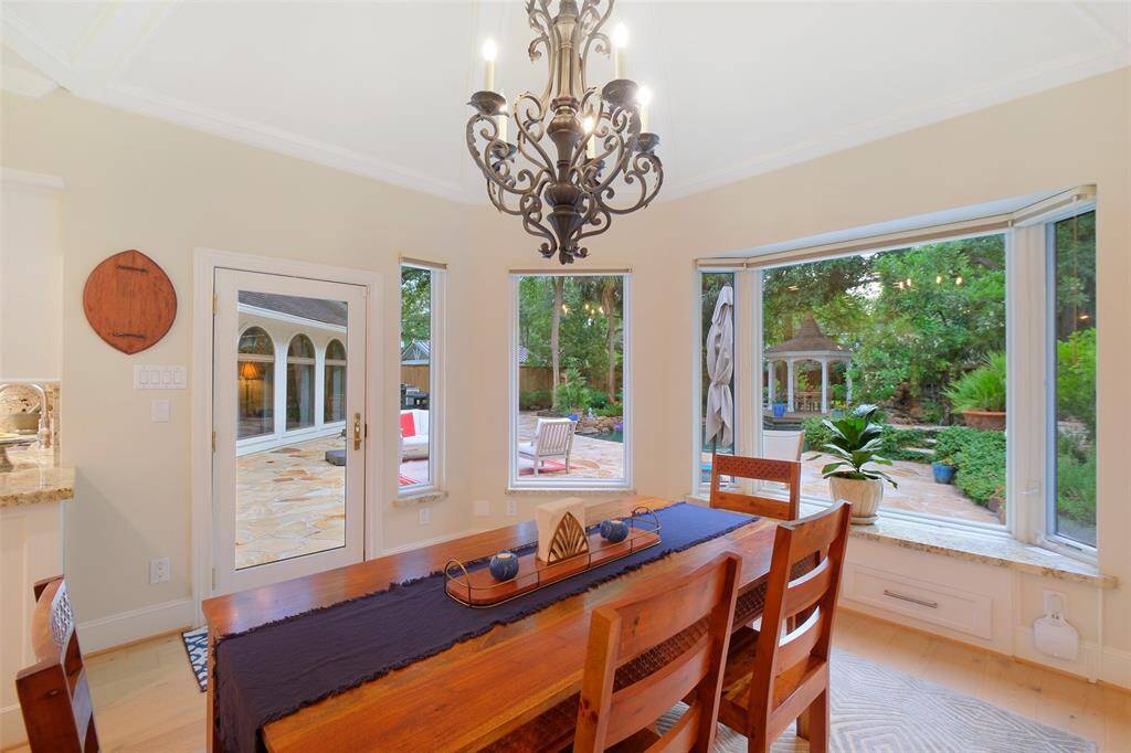This light gathering Breakfast Room starts your day the right way with the scenic wrap-a-round windows offering even more scenic views of the backyard oasis.