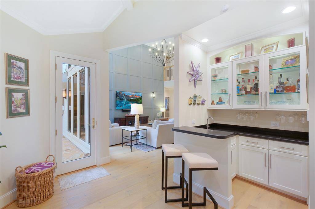 Adjacent to the Living Room is a Family Room furnished with a wet bar and wine chiller.