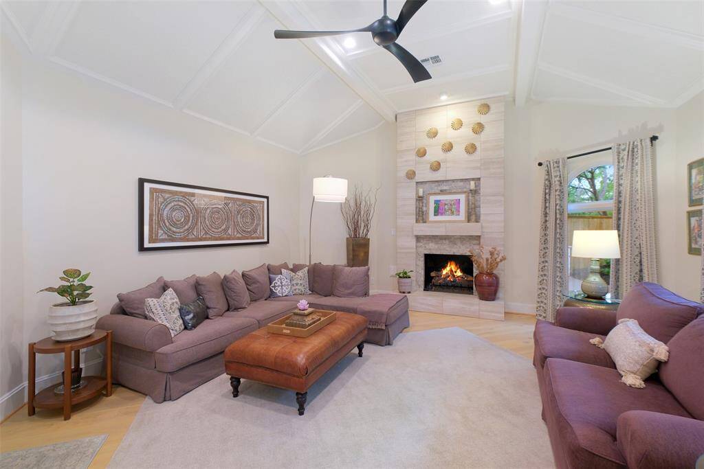 Relax in the Family Room and enjoy the ambiance of the gas log fireplace and those panoramic pool and deck views accented by custom designed draperies.
