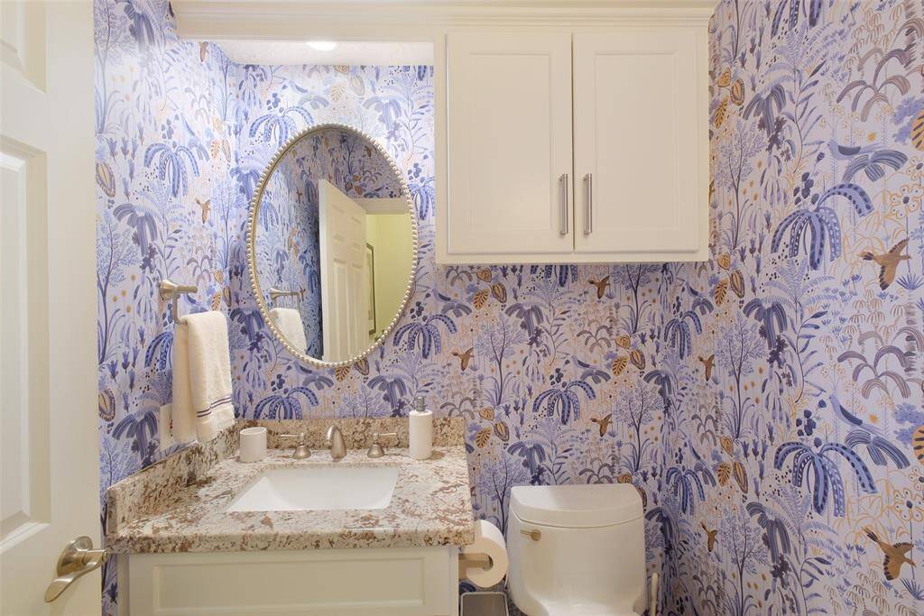 This Powder Bath with granite countertops services the Living Room area of the home. Please note this is the easy removable wallpaper.