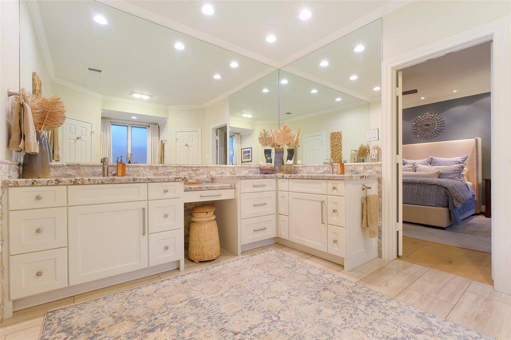 The Primary Bathroom boasts true En Suite Luxury while featuring His/Her Sinks and a Vanity Area, Custom Cabinets, Wonderful Lighting, and Granite Countertops. His and Her Walk-In Closets with built-ins complete the suite in fine fashion!