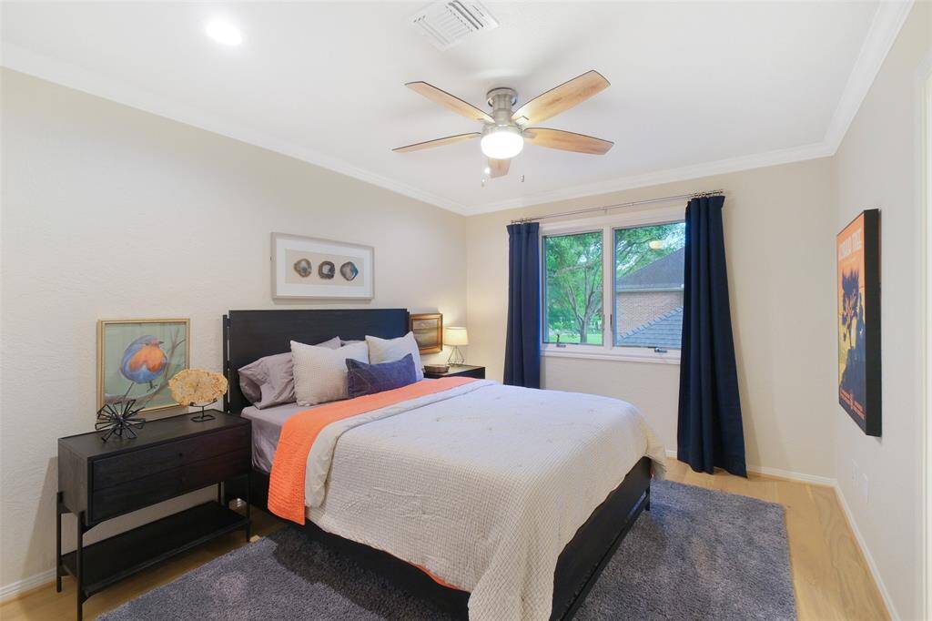 Upstairs, finds this luxurious Secondary/Guest Bedroom with an En Suite Bathroom and a Walk-in Closet. Designer Drapes, Custom Paint, and lovely appointments. Well done, indeed!