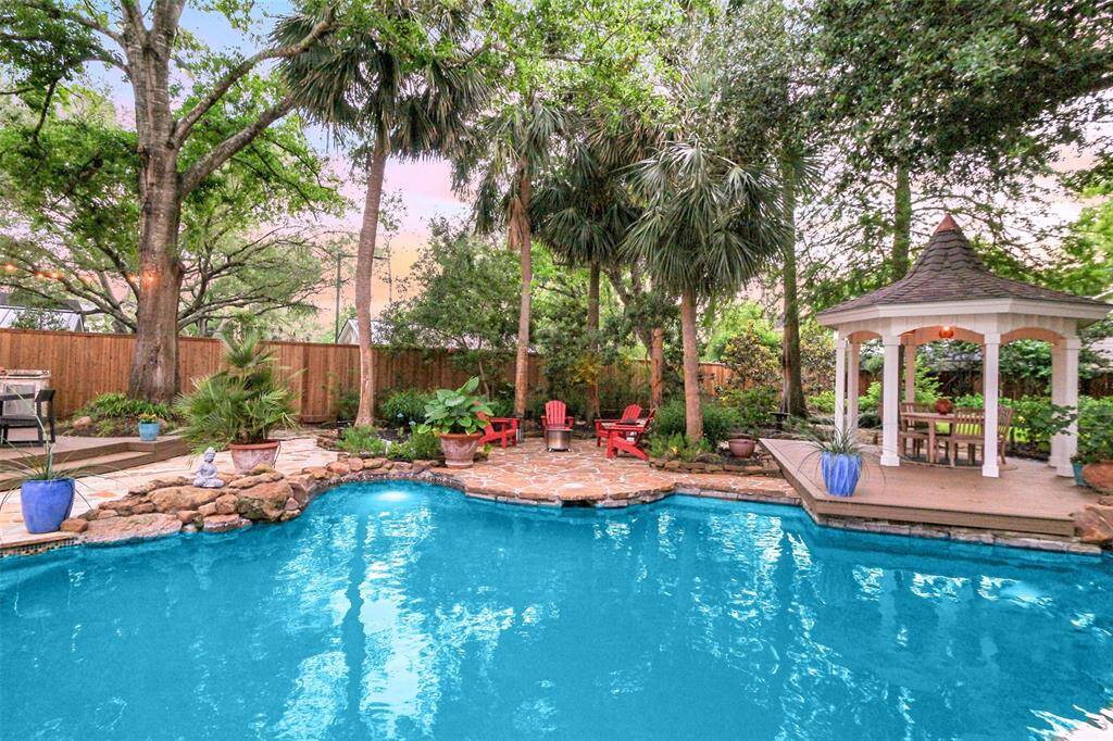Another inviting patio space poolside and under the palm trees! Notice the 7 ft tall wooden privacy fencing.