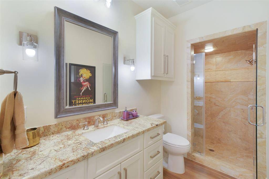 The Guest House offers a Full Bathroom complete with a Shower, Granite Countertops,Custom Cabinets, and Tile Flooring.