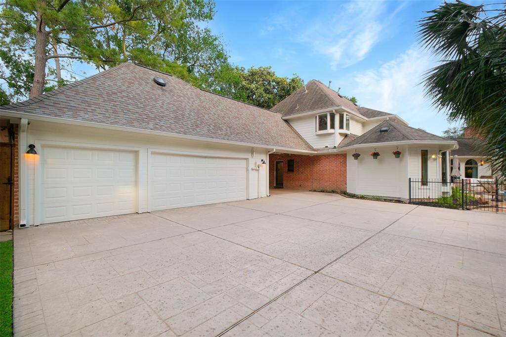 Private 3 car garage area, located behind a private driveway gate.  Note the porte-cochere and gate to enter backyard to pool area.