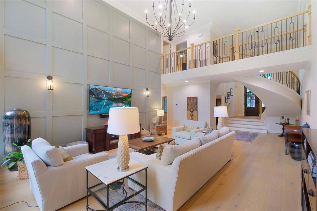 Another angle of the inviting living room. Notice the 2-Story "Feature Wall" with integrated lighting, TV mount and hidden in-wall A/V cabling.