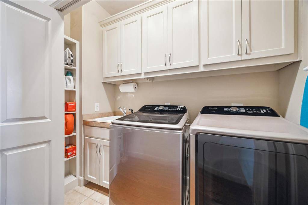 The utility room is conveniently located on the 3rd floor with the primary bedroom and secondary bedroom. Newer washer and dryer (2021) included, storage cabinets and shelves plus a rare-to-find utility sink.