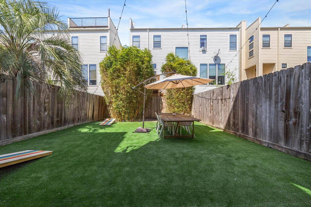 Another look at this HUGE back yard. Tons of turf space; allows lots of room for pets/kids to play. Plenty of room to dine al fresco and for yard games. The backyard is lined by mature bamboo for added privacy.