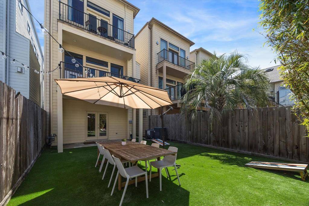 Another look showing this fabulous turfed backyard. Also note the 2 large balconies on the 2nd and 3rd floors! Multiple outdoor spaces!