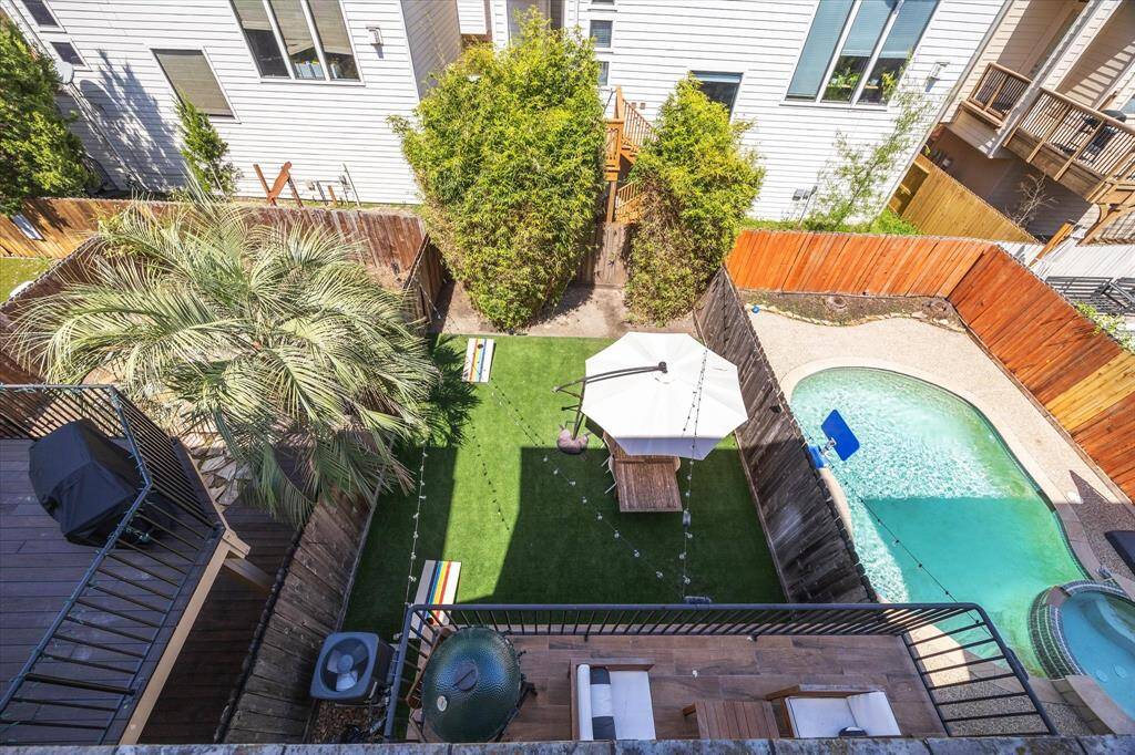 A look down towards this pool-sized backyard from the 3rd floor balcony.