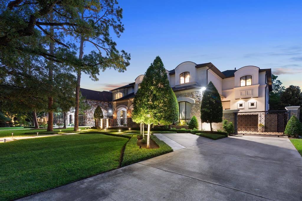 5219 Pine St. is a beautiful estate commanding a first impression with its stone and stucco façade, arched windows, and meticulously manicured landscaping. Illuminated by elegant exterior lighting, the sweeping driveway and stately architecture set the tone for the luxury that lies within.