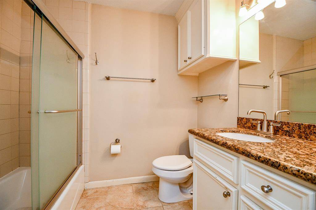 Updated bathroom with granite and standing shower/tub combo.