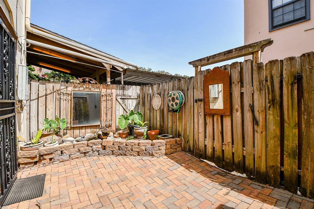 Charming back patio with extra storage closet.
