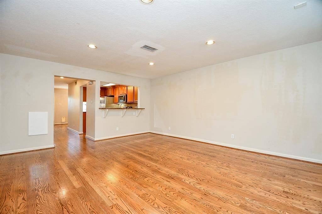 Spacious living area seamlessly connected to the kitchen for an open, inviting atmosphere. Extra countertop space for seating.