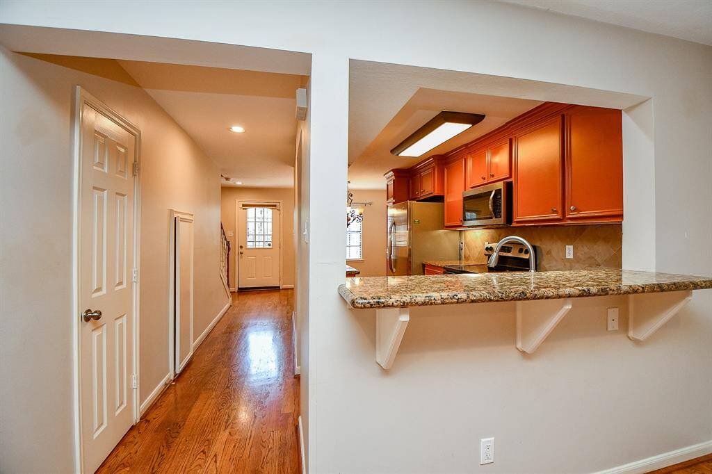 Convenient half bath and ample storage closet located just off the kitchen hallway.