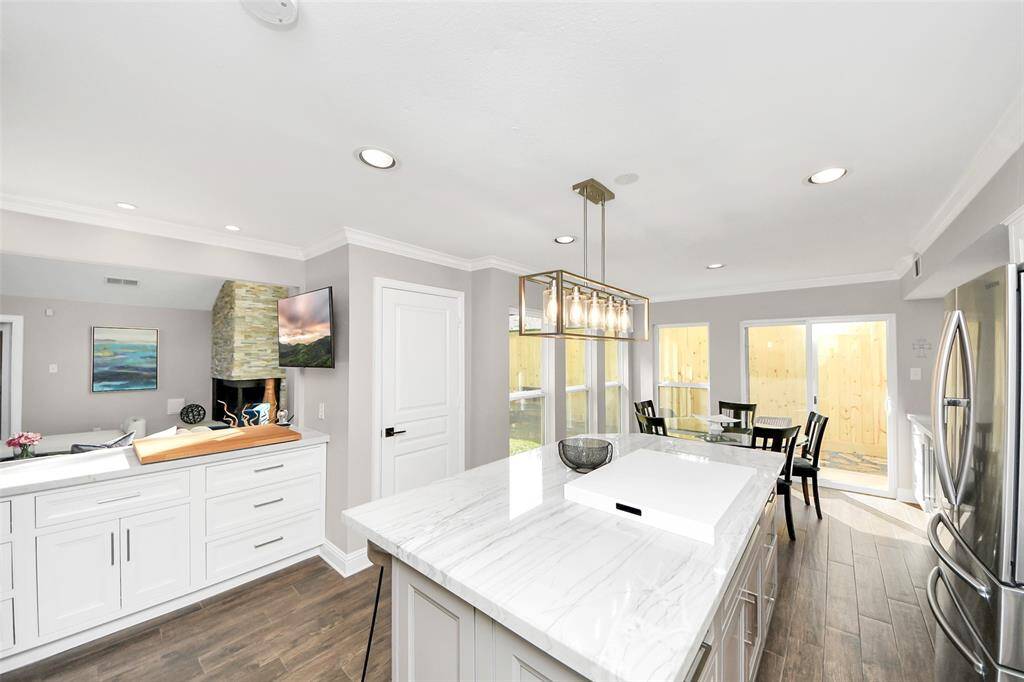 A sensational modern kitchen with high end Quartzite countertops and an oversized island, perfect for entertaining!