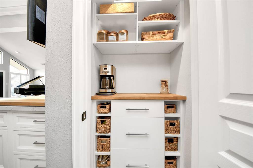 A barista pantry with added storage and electric outlet meets all your morning needs!