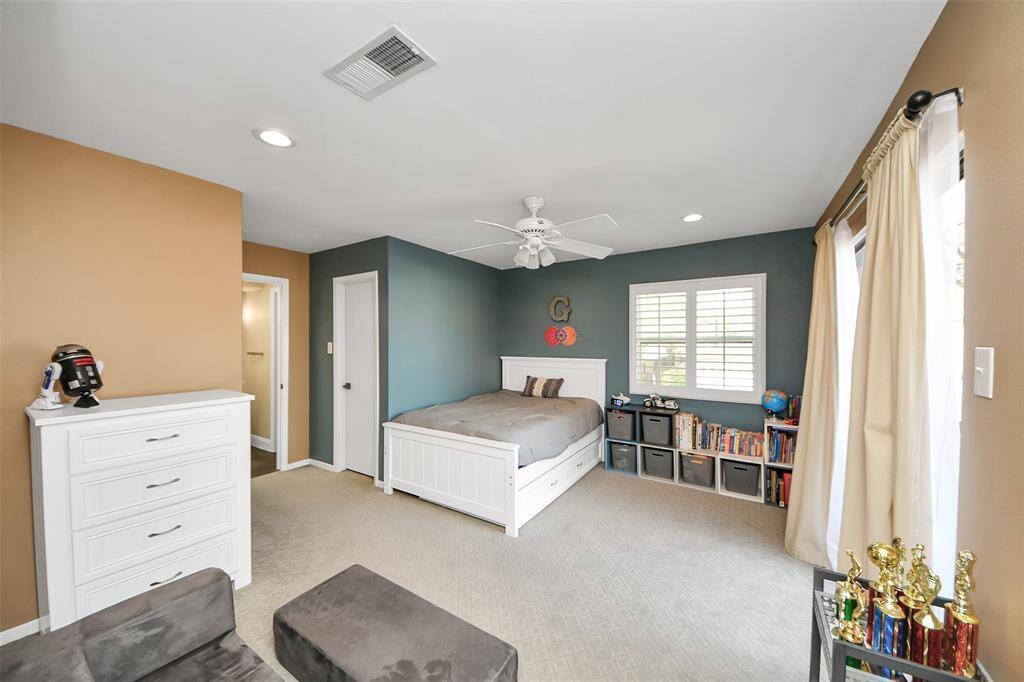 This large secondary bedroom includes a walk-in closet and gorgeous views of the outdoors.