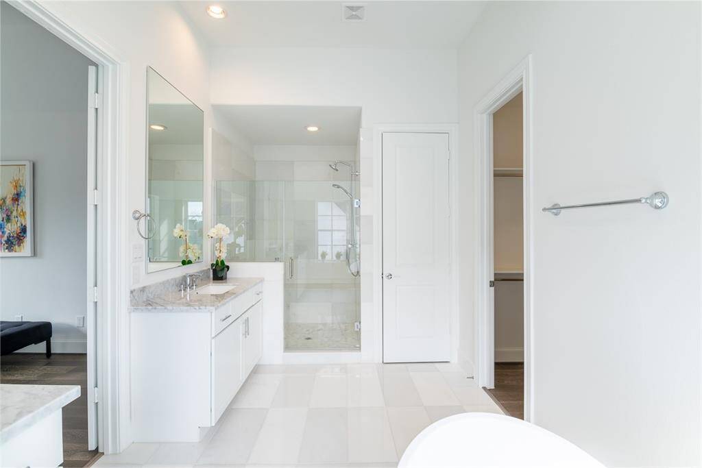 Freestanding shower in the Primary bathroom with Hans Grohe plumbing fixtures.  (similar home and features)