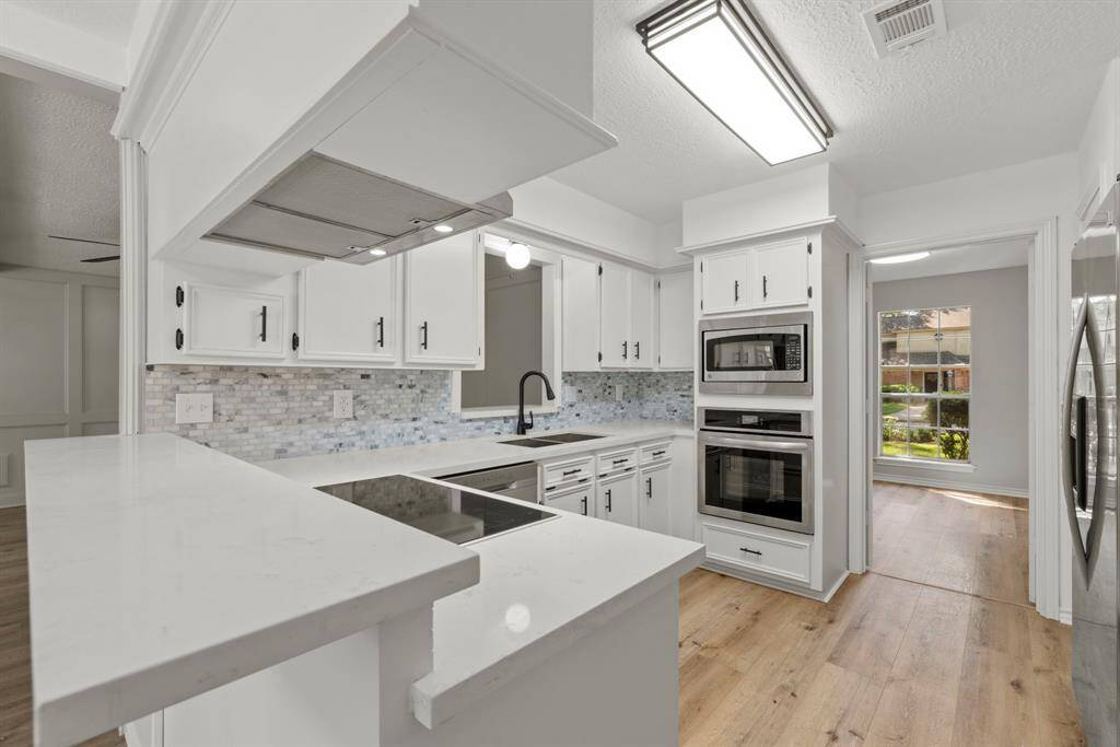 This kitchen is ready for the chef in your life! Updated and recently replaced stainless steel appliances throughout, quartz counter tops, grey/white tile backsplash, updated paint on cabinets and updated hardware!