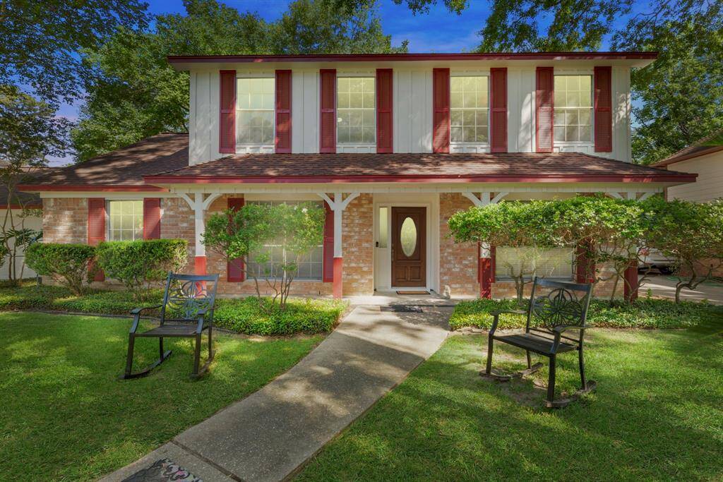 This two story home has lush landscaping that draws you right up the walk way and onto the long covered front porch!