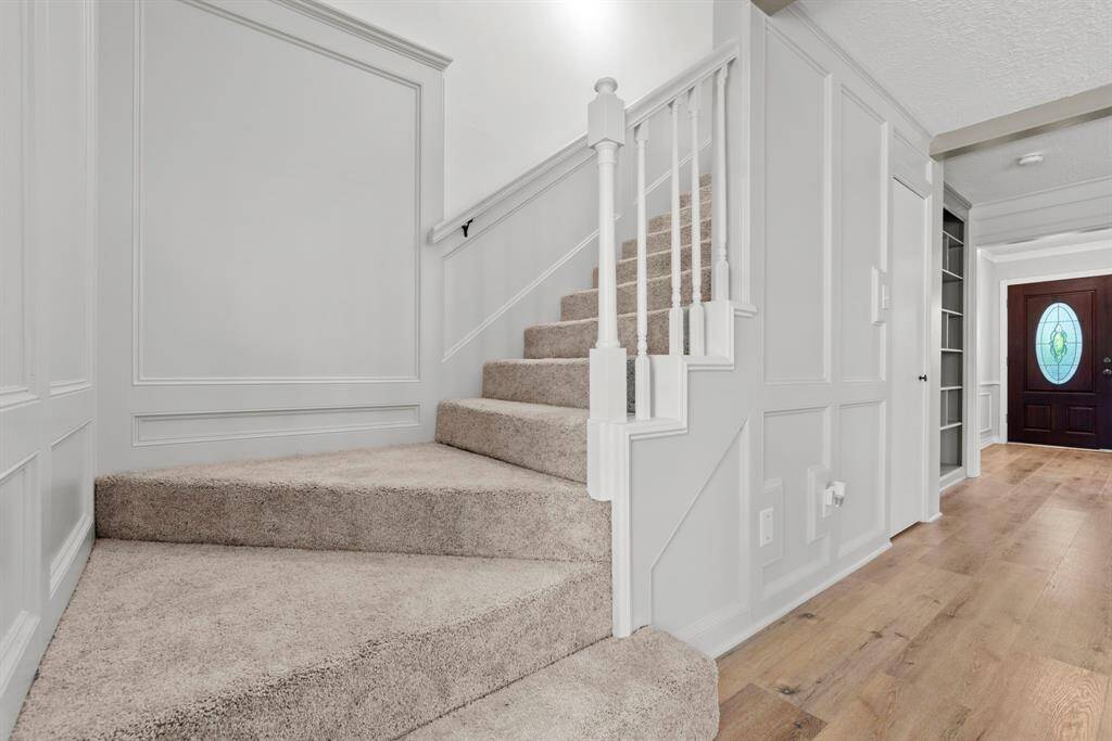 Let's head upstairs. Walls, spindles, paneling- all recently painted! Carpet recently replaced! Light fixture recently replaced!