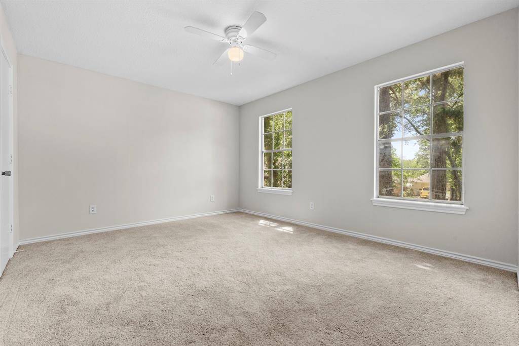 This secondary bedroom has recently replaced carpet, a new ceiling fan and fresh neutral paint!