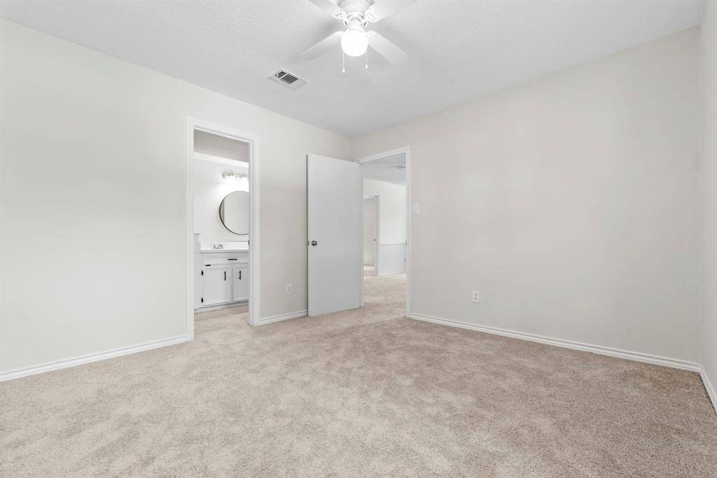 This bedroom upstairs has access to the upstairs secondary full bathroom. Again you'll notice recently replaced carpet, fresh neutral paint with white accents, and a new ceiling fan!