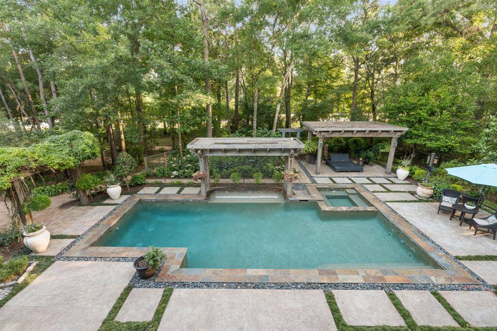 A close up of the views of the back garden and pool from the balcony.  Not seen is a grassy area on the left side of the backyard.