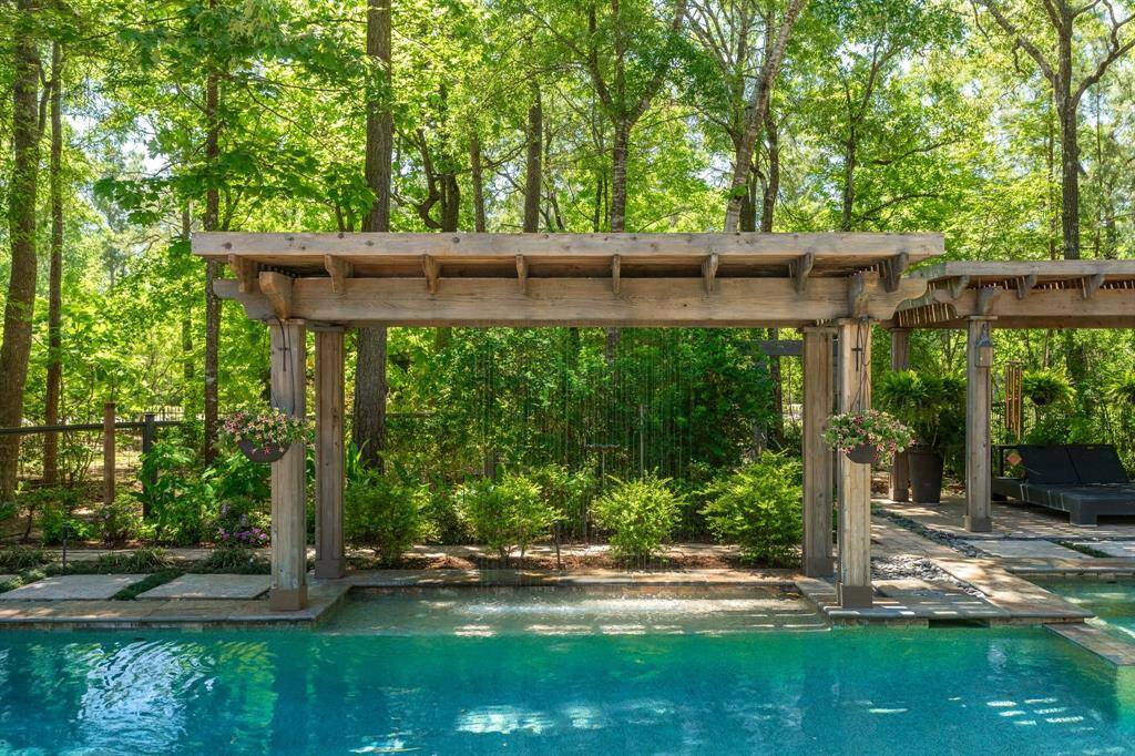 The water feature is a rain shower, everyone of all ages will love this!  Imagine yourself relaxing in this pool, you will be on vacation anytime you enter this backyard!