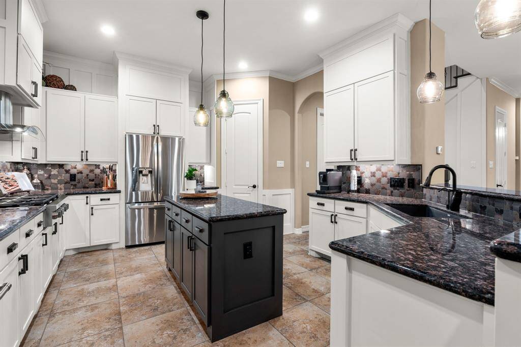 This kitchen is a chefs delight!  With abundant storage and counters space! The door you see leads to the walk in pantry which is also with plenty of space!