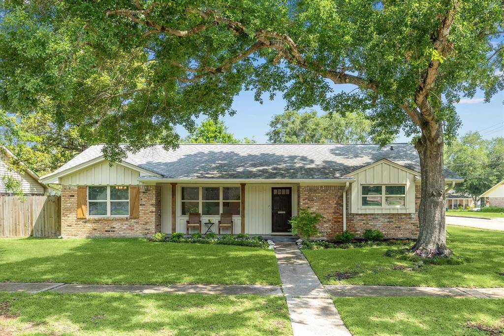 Up the sidewalk to the sitting porch where you may relax and meet the neighbors.
